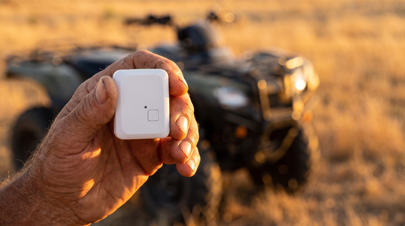 Farmer working alone in remote hilly Australian paddock with a pocket IoT safety tracking device